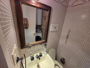 a bathroom with a sink and a mirror and a toilet at Punta del Este Santos Dumont apto 612 Centrico y a un paso de la playa in Punta del Este +7 photos