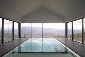 a swimming pool in a house with a view at Silken Mezio National Park in Soajo