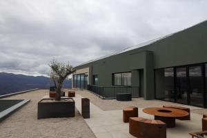 a building with benches and tables on a patio at Silken Mezio National Park in Soajo