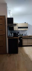 a kitchen with a stove and a counter top at Karola Szymanowskiego 2 Apart in Chełm