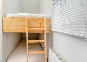 a bunk bed in a room with a window at Killerby Old Hall in Scarborough +12 photos