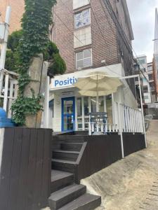 a restaurant with an umbrella in front of a building at CASA NANACINE Center of Seoul Itaewon, Myungdong, Namsan in Seoul