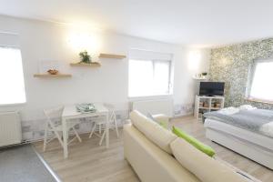a living room with a couch and a table at Stardust apartman in Pécs