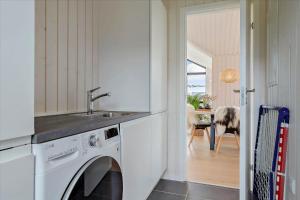 a kitchen with a washing machine and a sink at 30458-Odder-Strandvaenget-44 in Odder