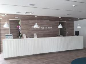 a lobby with a reception counter with a wall at Hotel Agua Azul - Adults Only in Benidorm