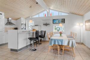 a kitchen and dining room with a table and chairs at 30516-Odder-Birkevaenget-7 in Odder