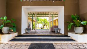 an entrance to a house with potted plants at Waves Hostel in Negombo