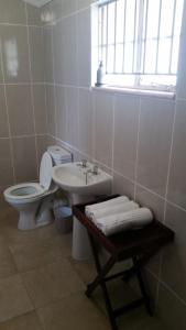 a white bathroom with a toilet and a sink at Unit51 MarinaGlen Holiday Resort in Marina Beach