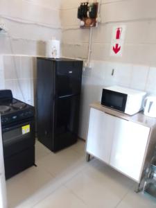 a kitchen with a black refrigerator and a stove at Unit51 MarinaGlen Holiday Resort in Marina Beach