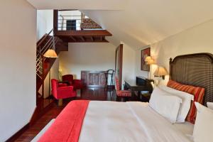 a hotel room with a bed and a staircase at Pousada Convento de Tavira in Tavira