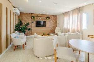 TV a/nebo společenská místnost v ubytování Condo. c/ Piscina e Academia a 70m da Praia - SMA