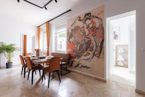 a dining room with a large painting on the wall at Little Japan in Düsseldorf +22 photos