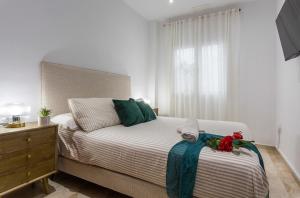 a bedroom with a bed and a dresser and a window at Cadiz Playa 3 Rooms in Cádiz