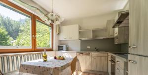 a kitchen with a table with a bowl of fruit on it at Gästehaus Kerber in Steeg