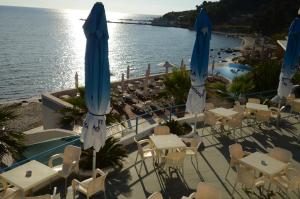 a view of the beach from a restaurant with tables and umbrellas at West Beach Apartment in Durrës