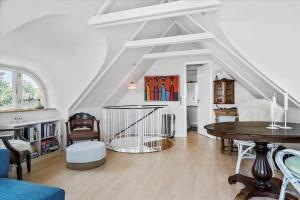 a living room with a table and some chairs at 30508-Odder-Dyngby-Havvej-42 in Odder