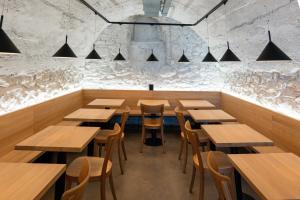 a dining room with wooden tables and chairs at Martigny Youth Hostel in Martigny-Ville