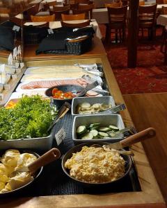 a buffet with many trays of food on a table at Laivahostel S/S Bore in Turku +24 photos