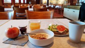 a table with a bowl of cereal and a plate of food at Laivahostel S/S Bore in Turku