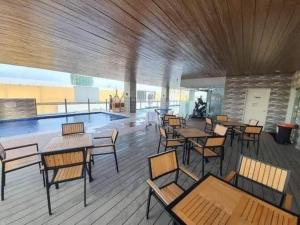 a room with tables and chairs and a swimming pool at Sunvida Tower staycation unit 2503-2504 in Cebu City +19 photos