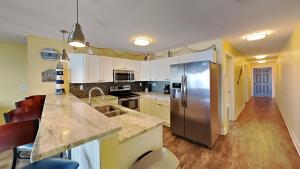 a kitchen with a stainless steel refrigerator at Put-in-Bay Waterfront Condo #104 in Put-in-Bay