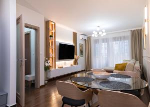 a living room with a table and a couch at A&T Lux in Podgorica