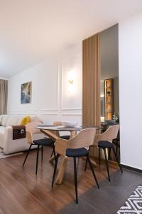 a living room with a dining room table and chairs at A&T Lux in Podgorica