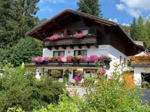 a house with flower boxes on the side of it at Haus Latschenheim in Ramsau am Dachstein