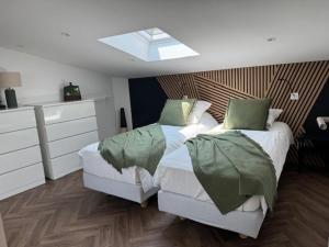 a bedroom with two beds and a skylight at La Grange, Vendée, Nesmy in Nesmy