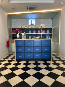 a store with blue cabinets and a checkered floor at Le Embassy Hotel Georgetown in George Town
