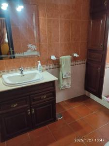 a bathroom with a sink and a mirror at Charming House with Pool in Buenavista del Norte in Buenavista del Norte
