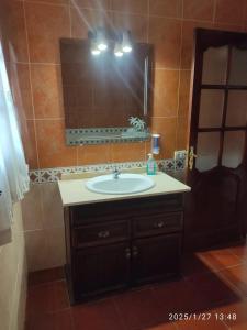 a bathroom with a sink and a mirror at Charming House with Pool in Buenavista del Norte in Buenavista del Norte +6 photos