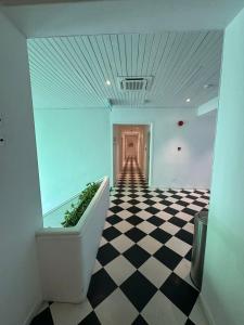 a room with a checkered floor and a hallway at Le Embassy Hotel Georgetown in George Town +10 photos