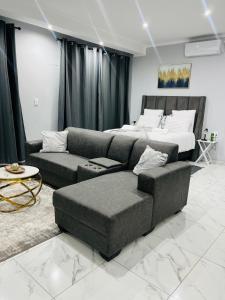 a living room with a couch and a bed at Audreys Haven Self catering accommodation in Rundu