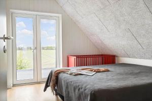 a bedroom with a bed and a large window at 30467-Odder-Ravnsager-15 in Odder