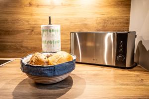 a bowl of bread sitting next to a microwave at 003 - Monument - 1 bedroom - 2 beds - large living dining room in Brunsbüttel +92 photos