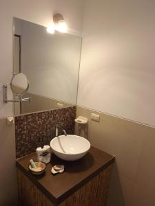 a bathroom with a sink and a mirror at Bamboo Lodge Paracas in Paracas +41 photos