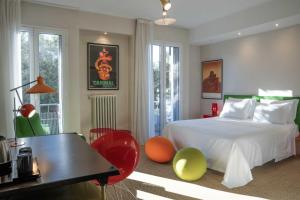 a bedroom with a bed and a desk and chairs at Boutique Hotel Trieste - Adults Only in Verona +20 photos