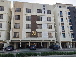 a large building with cars parked in front of it at Kanaf Luxury Apartment, two bedrooms and a hall in Quai