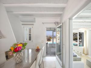 a dining room with a table and a view of the ocean at Villa in Mykonos with Sea View and Pool in Kalafatis