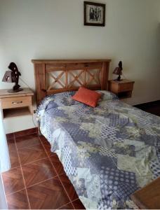a bed in a room with two nightstands and a bed sidx sidx sidx at Hostal la Caleta in Mar de Cobo