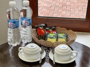a table with a bowl of chips and a bottle of water at Tam Coc Mountain Light Homestay in Ninh Binh