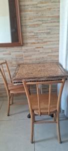 a wooden table and a wooden chair with a table and a bench at Bandeira do Brasil in Rio de Janeiro