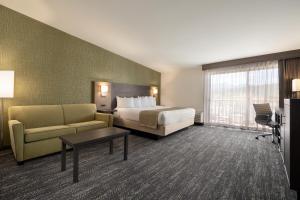 a hotel room with a bed and a couch at The Kendrick Hotel, an Ascend Collection Hotel in Flagstaff