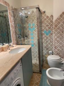 a bathroom with a sink and a washing machine at Apartment in Porto Cervo surrounded by greenery in Abbiadori +22 photos
