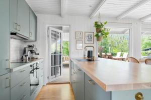 a kitchen with blue cabinets and a counter top at 30338-Odder-Skovlunden-11 in Odder +18 photos
