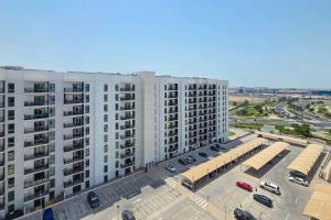 an aerial view of a large white building with a parking lot at 1BR -Marina Solene Yas Island 10 Min to Grand Prix in Abu Dhabi
