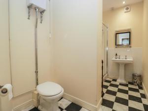 a bathroom with a toilet and a sink at The Old Kitchen in Grange Over Sands +49 photos