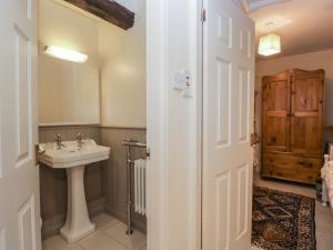 a bathroom with a sink and a mirror at Huntsman's Cottage in Grange Over Sands +47 photos