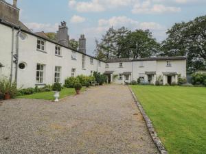 a row of white houses with a yard at Huntsman's Cottage in Grange Over Sands